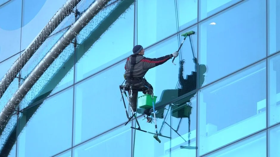 Cleaner using a vacuum in a stylish indoor setting, showcasing cleaning equipment and techniques.